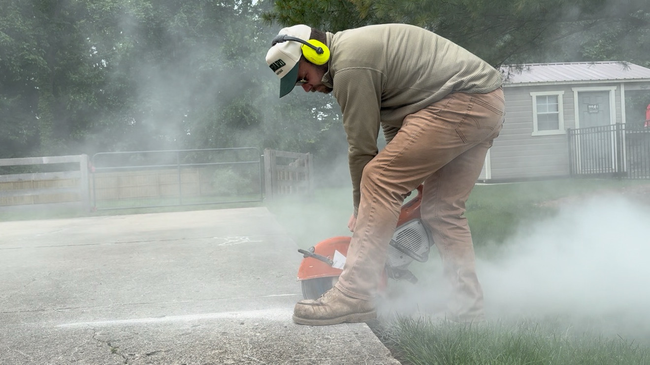 Queen City Hardscapes crew member working on a local outdoor project